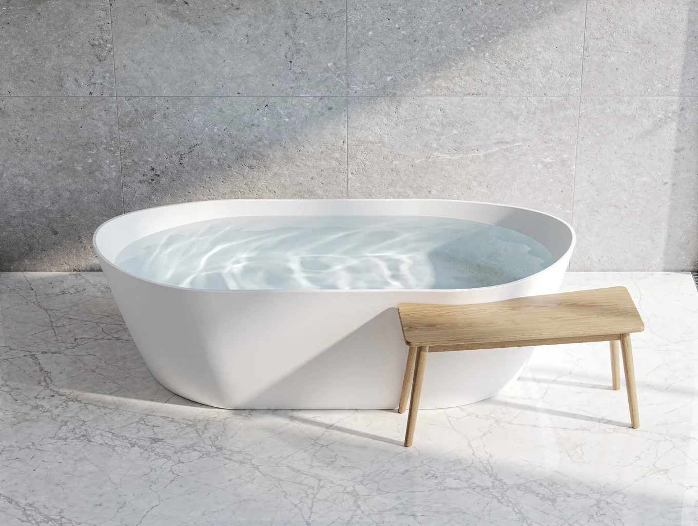 Freestanding soaking tub before a textured charcoal slate accent wall