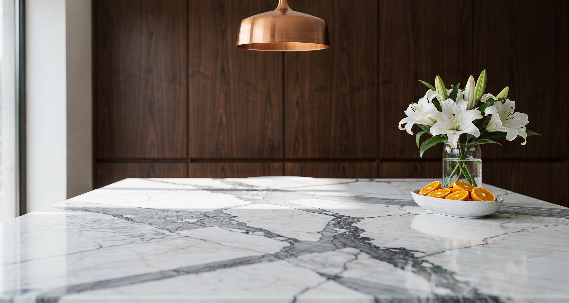 Calacatta quartz waterfall island with precision mitered stone edges