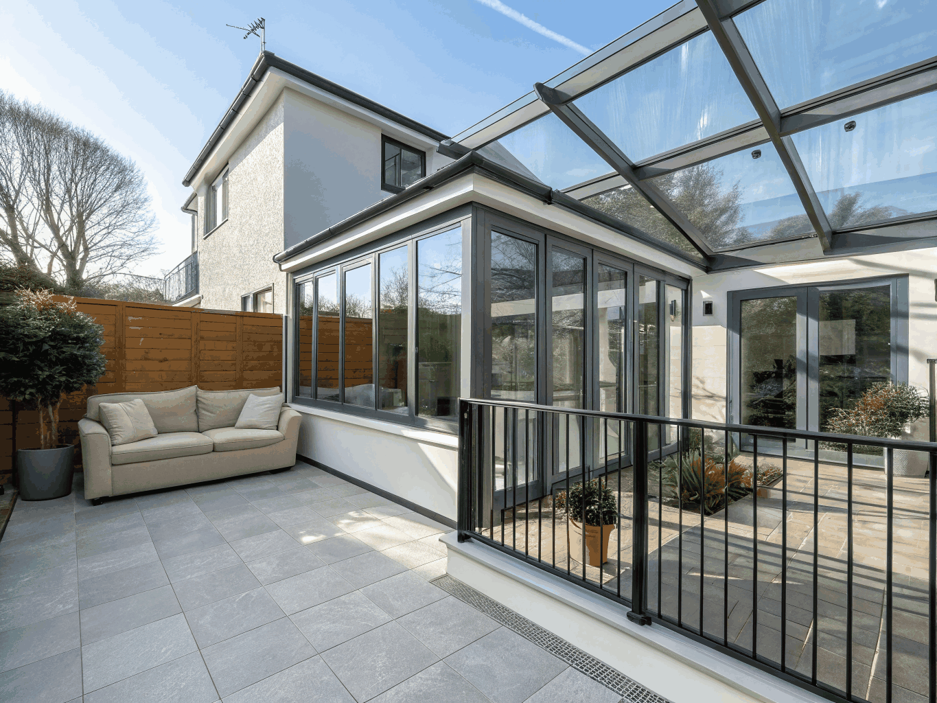 Bright sunroom addition with large windows and vaulted cedar ceiling